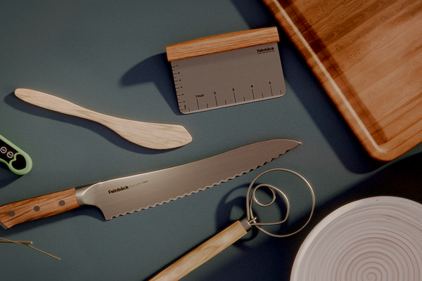 Woman in kitchen kneading bread dough