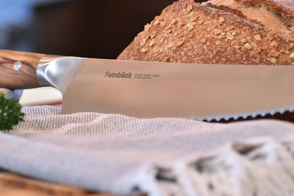 Woman in kitchen kneading bread dough
