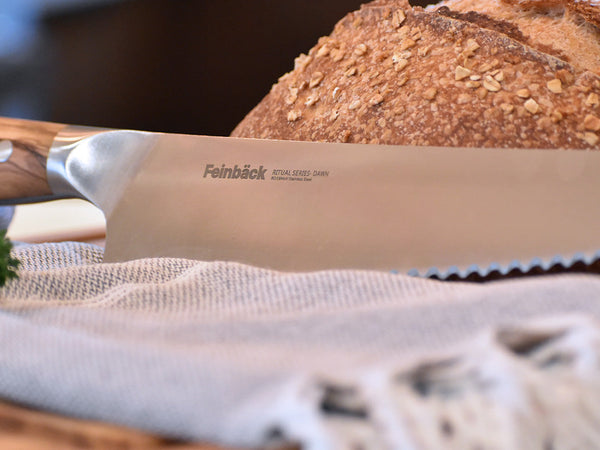 Woman in kitchen kneading bread dough