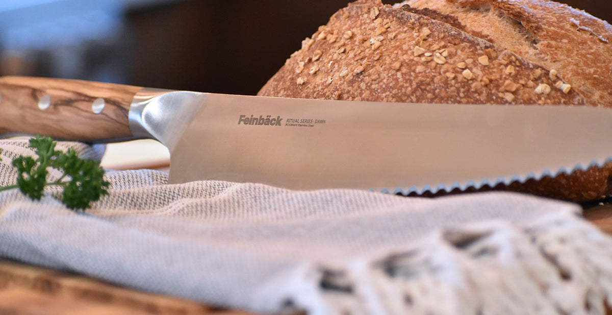 Woman in kitchen kneading bread dough